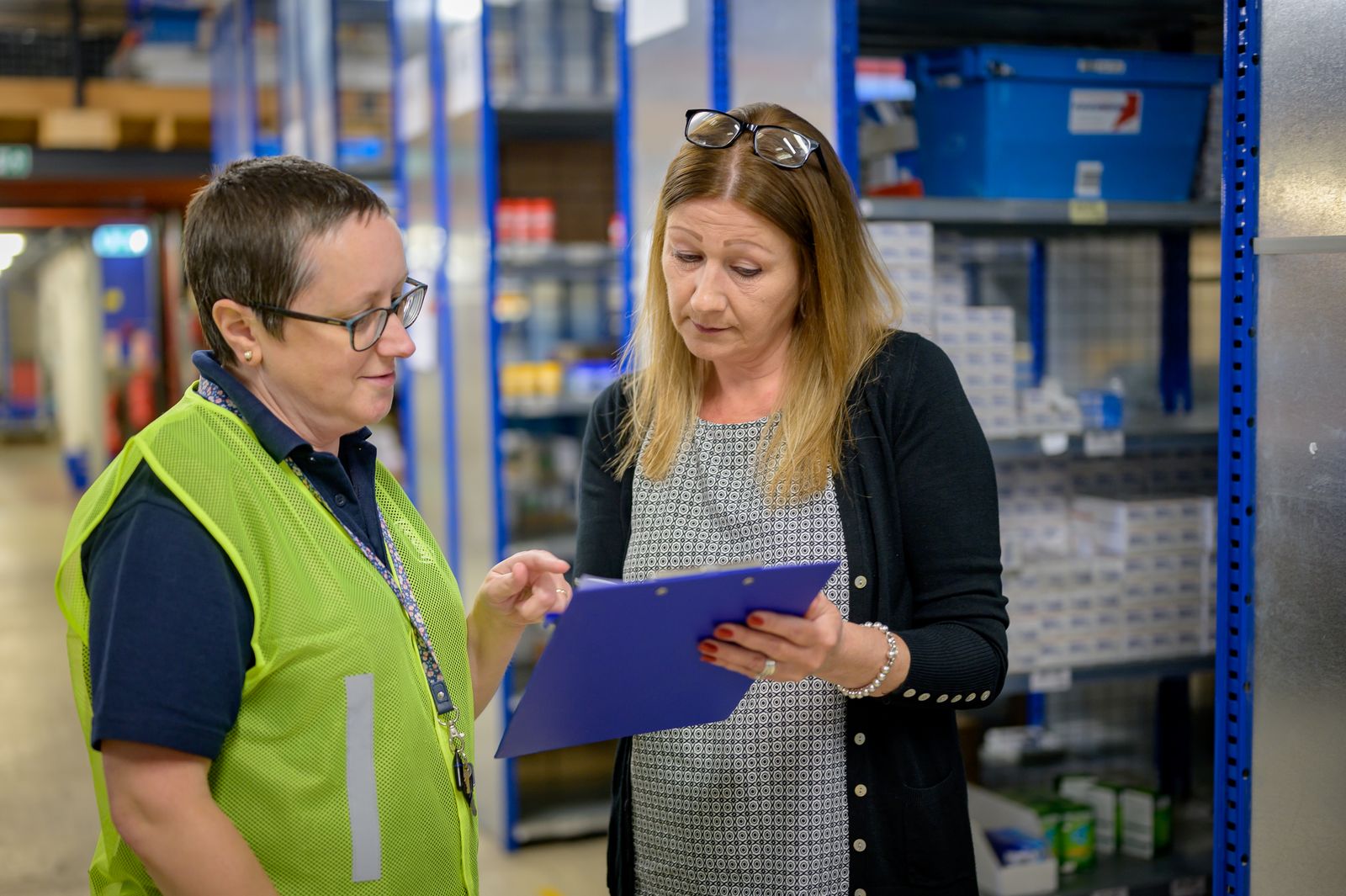 Warehouse professionals reviewing an operational checklist
